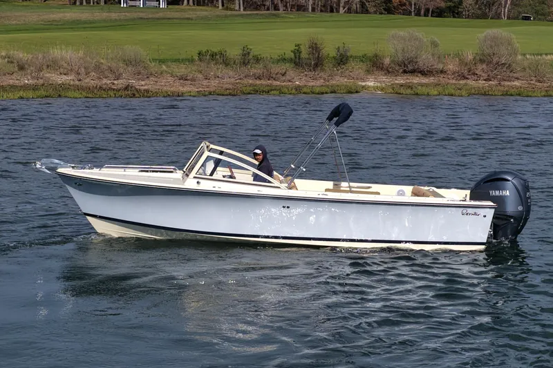 Slide: The Image of 2027 Rossiter 23 Closed Deck boat cruising on a calm lake with Yamaha outboard motor. - 9