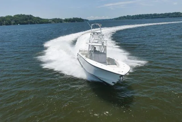 Slide: The Image of 2016 SeaVee 390 boat cruising swiftly on a sunny lake. - 29