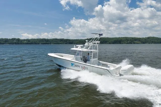 Slide: The Image of 2016 SeaVee 390 boat cruising on a lake under a partly cloudy sky. - 22