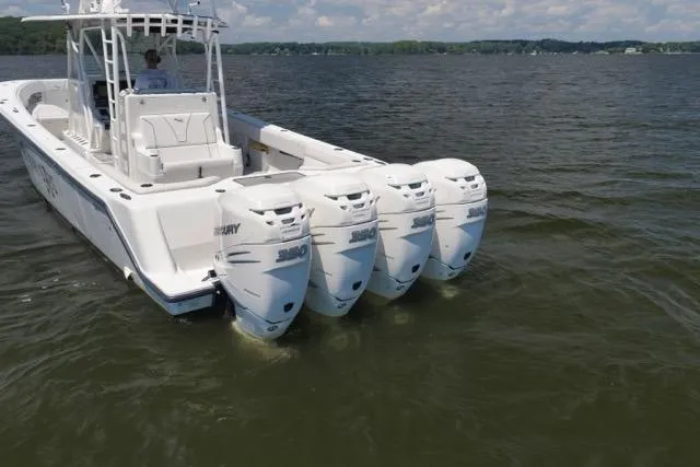 Slide: The Image of 2016 SeaVee 390 boat with triple Mercury outboard engines on a calm lake. - 6