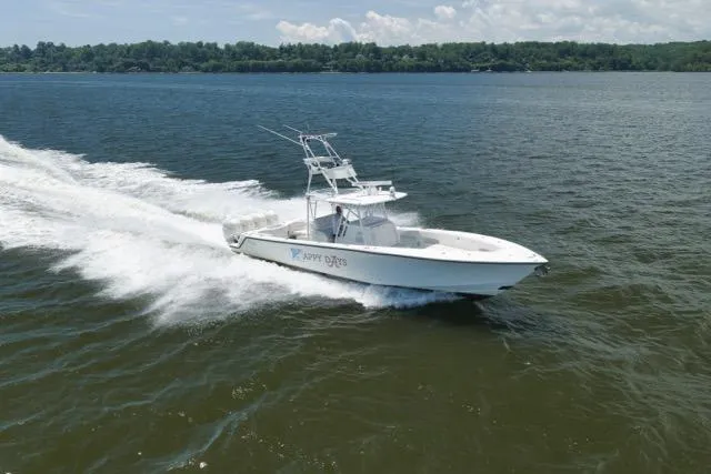 Slide: The Image of 2016 SeaVee 390 boat cruising on open water under a clear sky. - 24