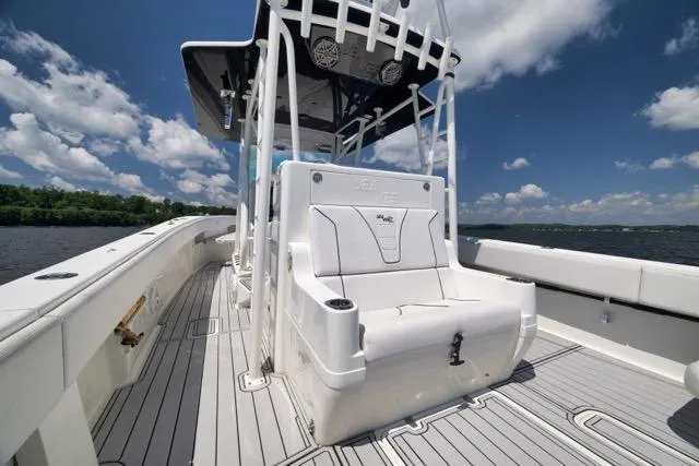 Slide: The Image of 2016 SeaVee 390 boat with sleek deck design under a clear blue sky. - 56