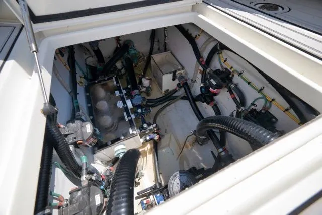 Slide: The Image of Engine compartment of a 2016 SeaVee 390 boat, showcasing intricate wiring and components. - 51