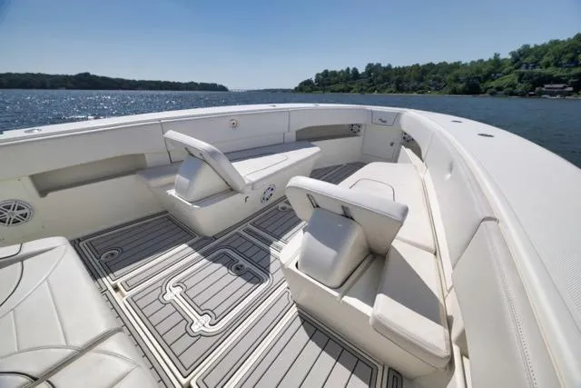 Slide: The Image of 2016 SeaVee 390 boat interior with cushioned seating and scenic water view. - 34