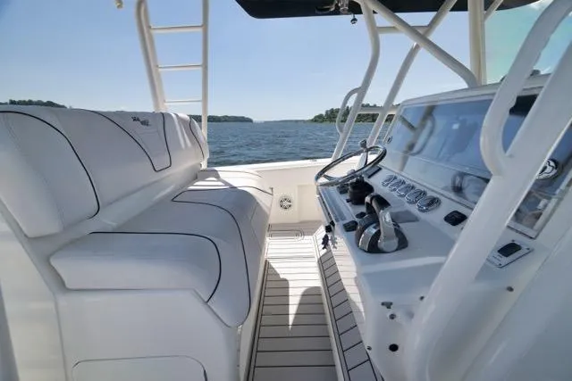 Slide: The Image of 2016 SeaVee 390 boat interior with helm, white seating, and ocean view. - 69