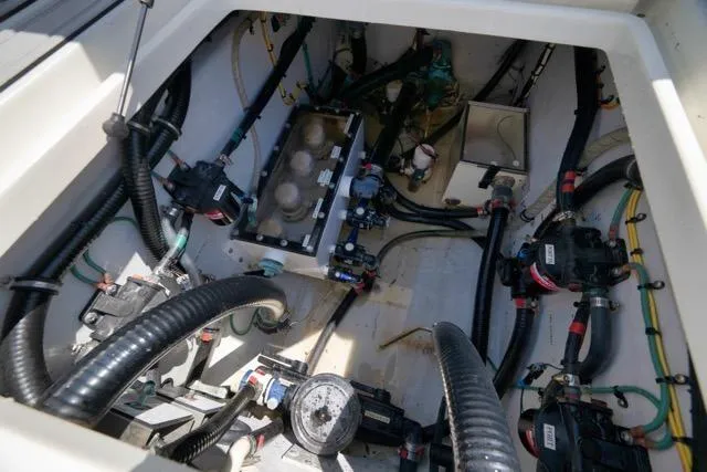 Slide: The Image of Engine compartment of a 2016 SeaVee 390 boat, showcasing intricate wiring and components. - 52
