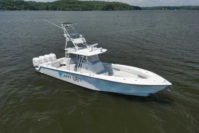 Slide: The Image of 2016 SeaVee 390 boat on calm water, featuring multiple outboard engines. - 14