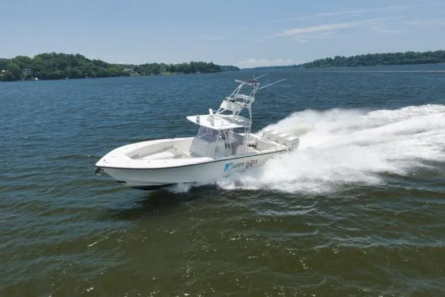 Slide: The Image of 2016 SeaVee 390 boat cruising on a lake under clear skies. - 28