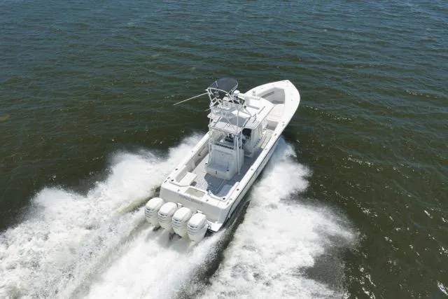 Slide: The Image of 2016 SeaVee 390 boat cruising on open water with powerful outboard engines. - 19