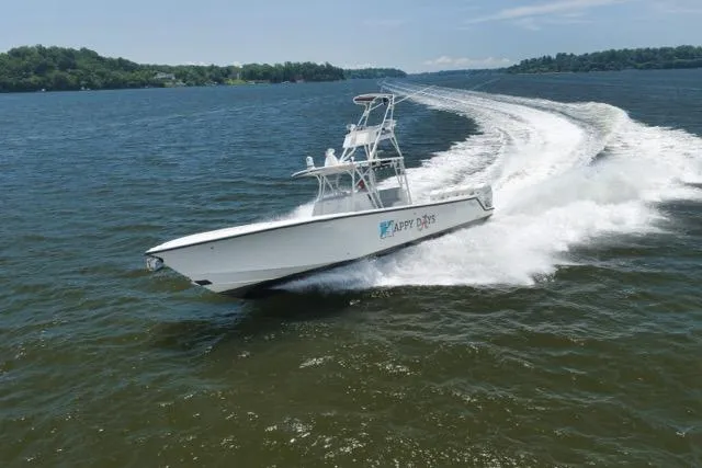 Slide: The Image of 2016 SeaVee 390 boat cruising on open water, creating a dynamic wake. - 26