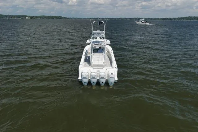 Slide: The Image of 2016 SeaVee 390 boat with four engines on open water, viewed from the rear. - 16