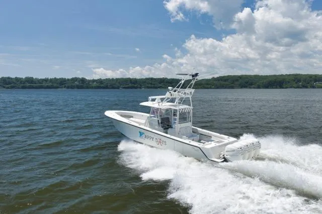 Slide: The Image of 2016 SeaVee 390 boat cruising on a lake under a partly cloudy sky. - 21