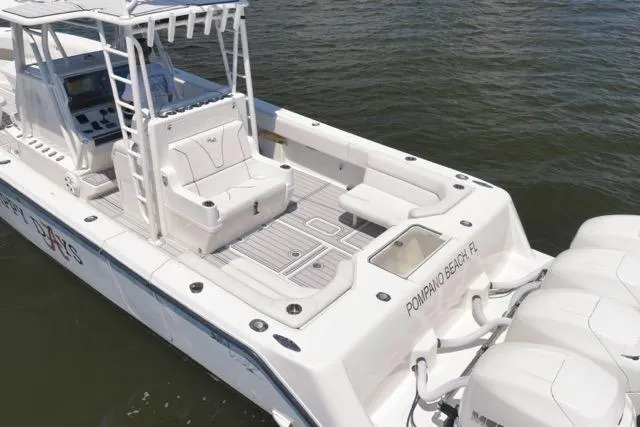 Slide: The Image of 2016 SeaVee 390 boat with spacious deck and multiple outboard engines, docked in Pompano Beach, FL. - 5