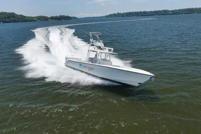 Slide: The Image of 2016 SeaVee 390 boat cruising swiftly on open water. - 30