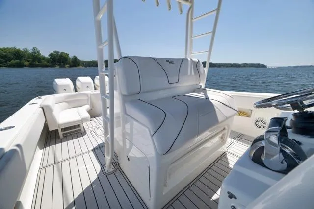 Slide: The Image of 2016 SeaVee 390 boat interior with white seating and steering wheel, on a sunny day. - 67