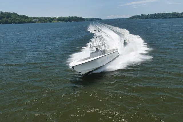 Slide: The Image of 2016 SeaVee 390 boat cruising swiftly on open water. - 27