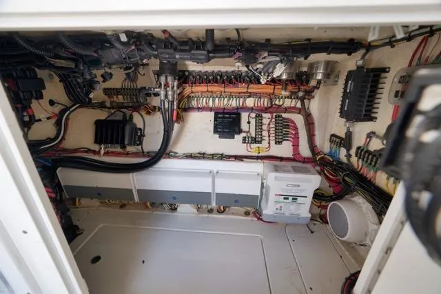 Slide: The Image of Electrical wiring system inside a 2016 SeaVee 390 boat, showcasing organized cables and components. - 46