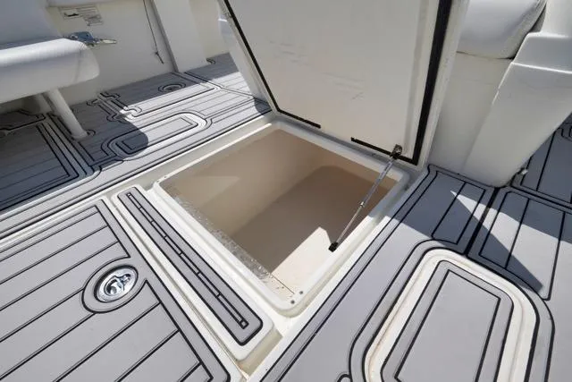Slide: The Image of Open storage compartment on 2016 SeaVee 390 boat deck with non-slip surface. - 53