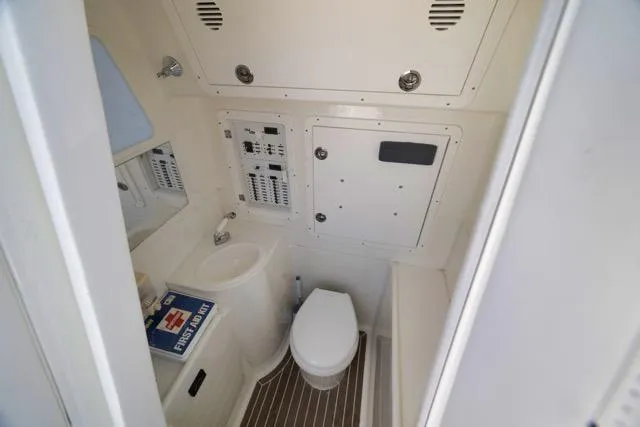 Slide: The Image of 2016 SeaVee 390 boat bathroom with toilet, sink, and control panel. - 45