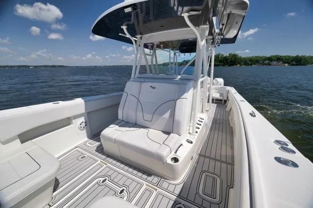Slide: The Image of 2016 SeaVee 390 boat with sleek seating and spacious deck on a sunny day. - 43