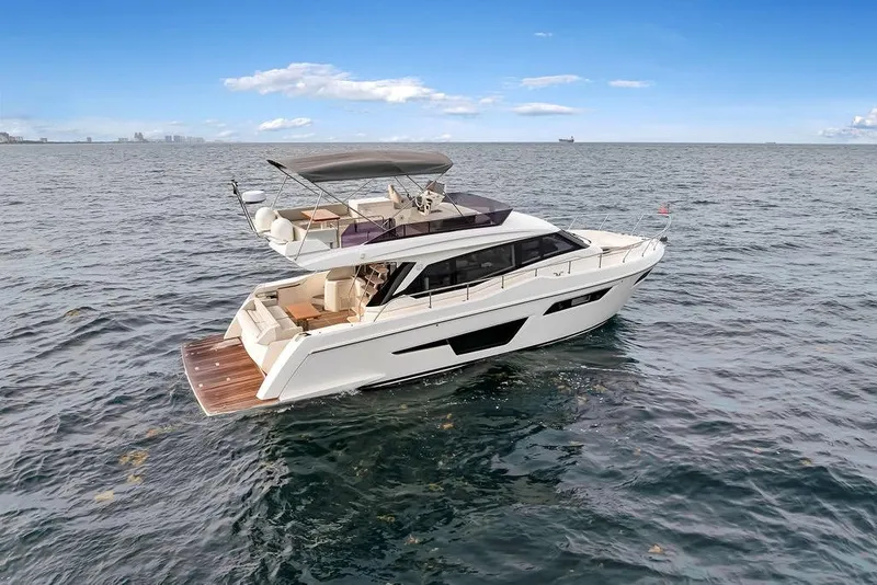 Slide: The Image of 2021 Ferretti Yachts 500 cruising on open sea under clear blue sky. - 5