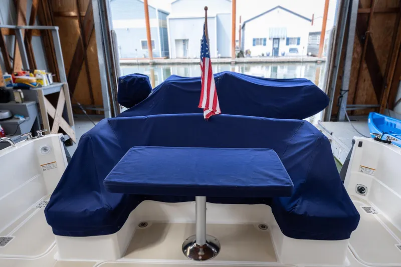 Slide: The Image of 2023 Sabre 45 Salon Express boat interior with blue covers and American flag. - 10