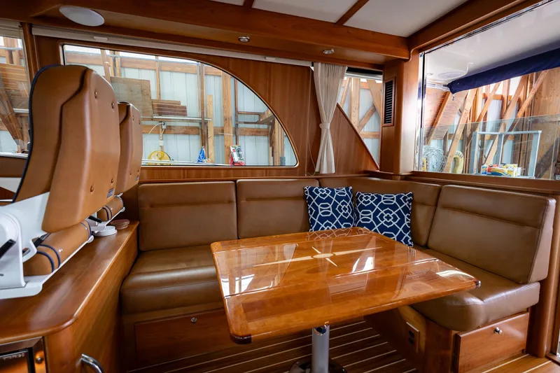 Slide: The Image of Luxurious interior of 2023 Sabre 45 Salon Express yacht with leather seating and wooden table. - 16