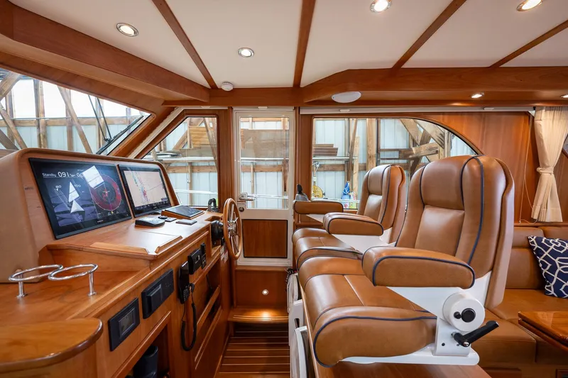 Slide: The Image of Luxurious interior of 2023 Sabre 45 Salon Express yacht with leather seating and navigation displays. - 18