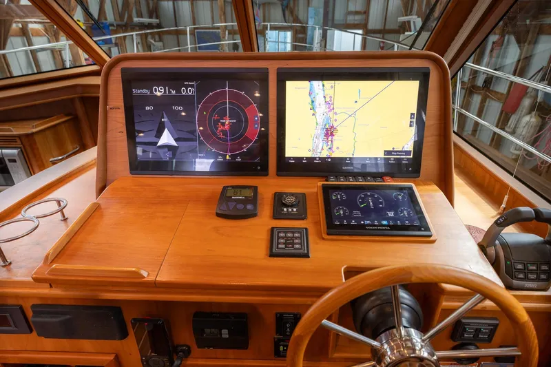Slide: The Image of Helm of 2023 Sabre 45 Salon Express with advanced navigation displays and controls. - 19