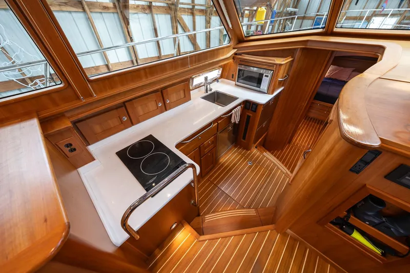 Slide: The Image of Luxurious 2023 Sabre 45 Salon Express yacht interior with modern kitchen amenities. - 23