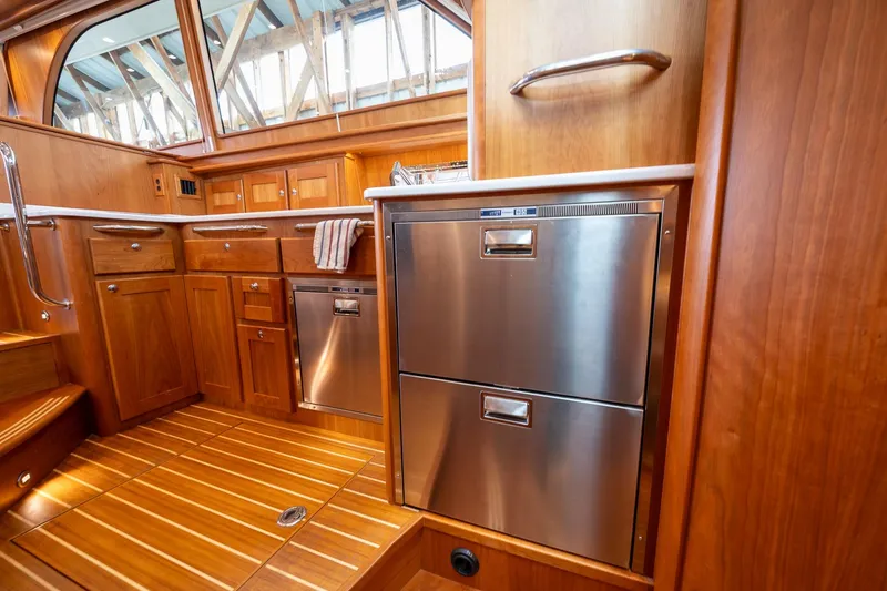 Slide: The Image of Luxurious interior of 2023 Sabre 45 Salon Express yacht with wood cabinetry and stainless steel appliances. - 25