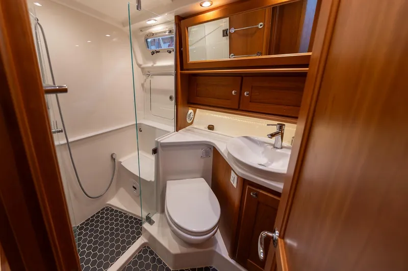 Slide: The Image of Luxurious bathroom in 2023 Sabre 45 Salon Express yacht with wood cabinetry and modern fixtures. - 31