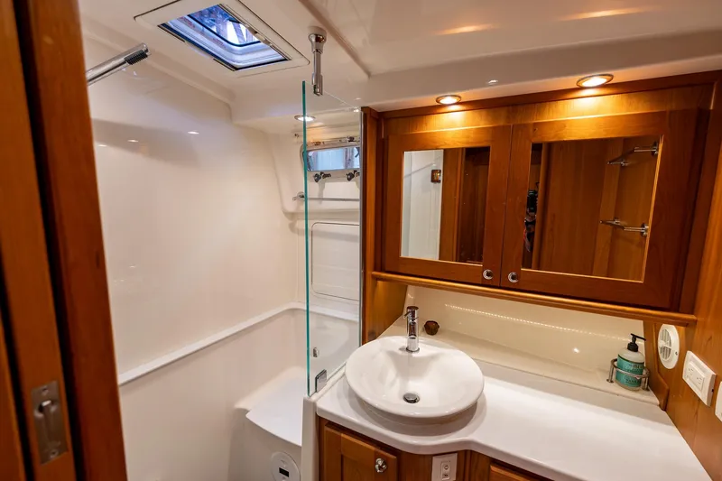 Slide: The Image of Luxurious bathroom in 2023 Sabre 45 Salon Express yacht, featuring elegant wood cabinetry and modern fixtures. - 32