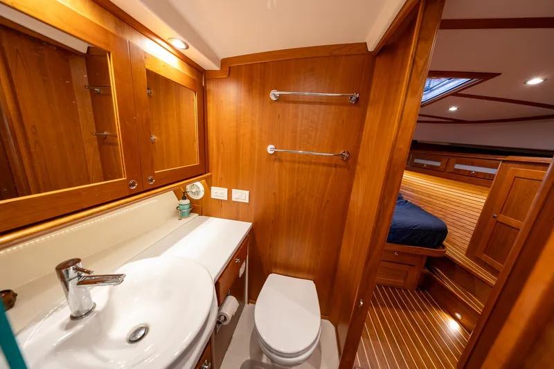 Slide: The Image of Luxurious 2023 Sabre 45 Salon Express yacht bathroom with wood finish and modern fixtures. - 33