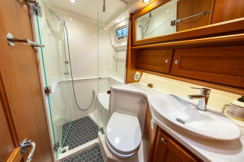 Slide: The Image of Luxurious bathroom in 2023 Sabre 45 Salon Express yacht with modern fixtures and wooden cabinetry. - 36