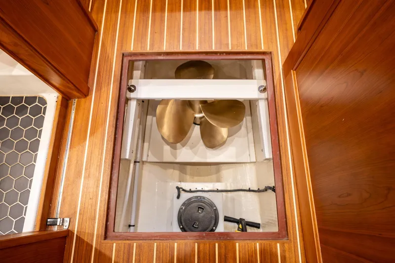 Slide: The Image of Engine room view of 2023 Sabre 45 Salon Express with wooden flooring and visible propeller. - 37