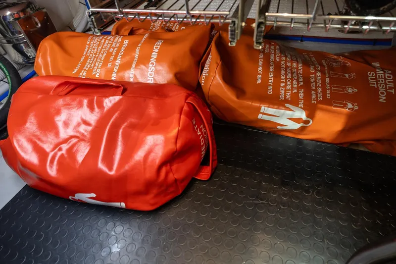 Slide: The Image of Orange immersion suits stored on a Sabre 45 Salon Express yacht, 2023 model. - 38