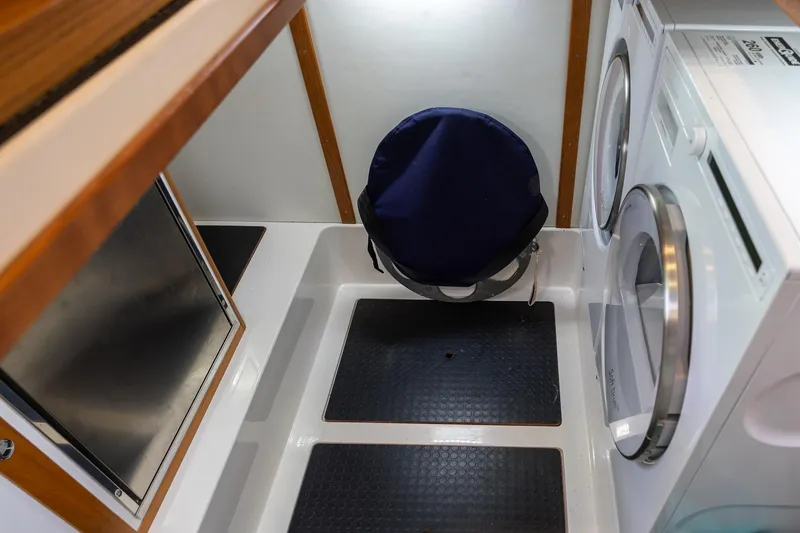 Slide: The Image of Laundry area in 2023 Sabre 45 Salon Express yacht with washer and dryer. - 40