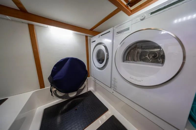 Slide: The Image of Laundry area inside 2023 Sabre 45 Salon Express yacht with washer and dryer. - 41