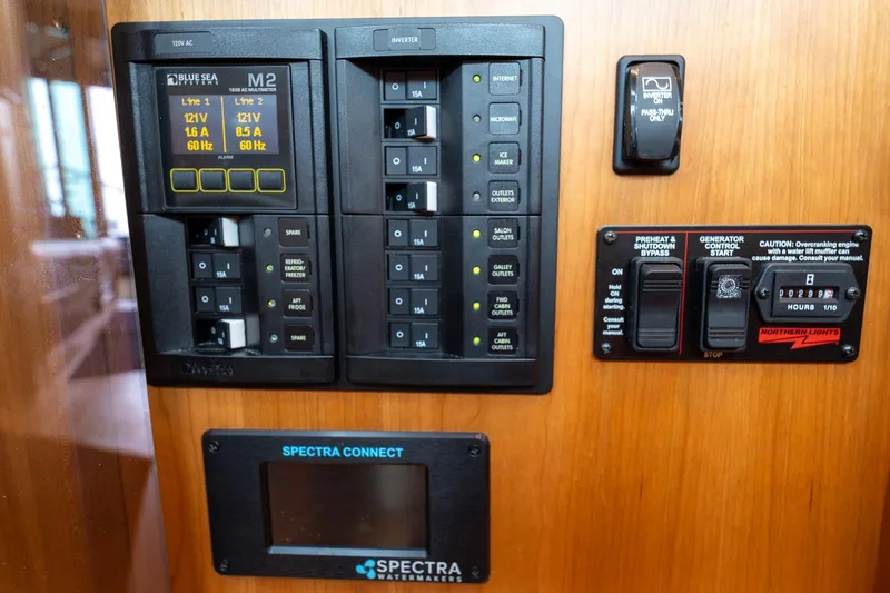 Slide: The Image of Electrical control panel on 2023 Sabre 45 Salon Express yacht, featuring various switches and displays. - 45
