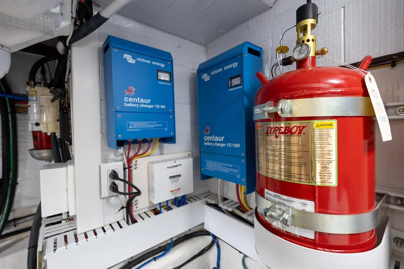 Slide: The Image of Engine room of 2023 Sabre 45 Salon Express with battery chargers and fire extinguisher. - 52