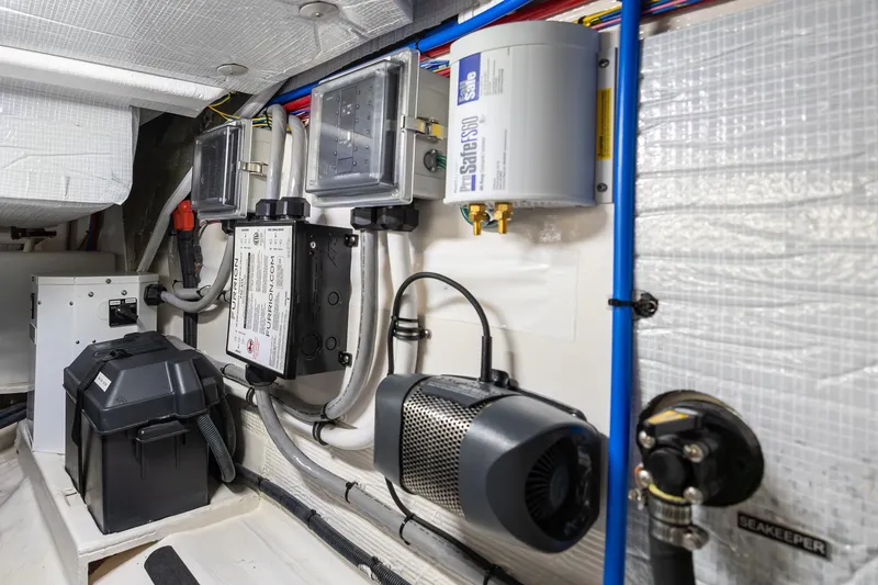 Slide: The Image of Engine room of 2023 Sabre 45 Salon Express with electrical components and wiring. - 53
