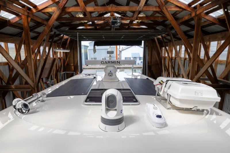 Slide: The Image of 2023 Sabre 45 Salon Express yacht in a wooden boathouse, featuring Garmin equipment. - 60