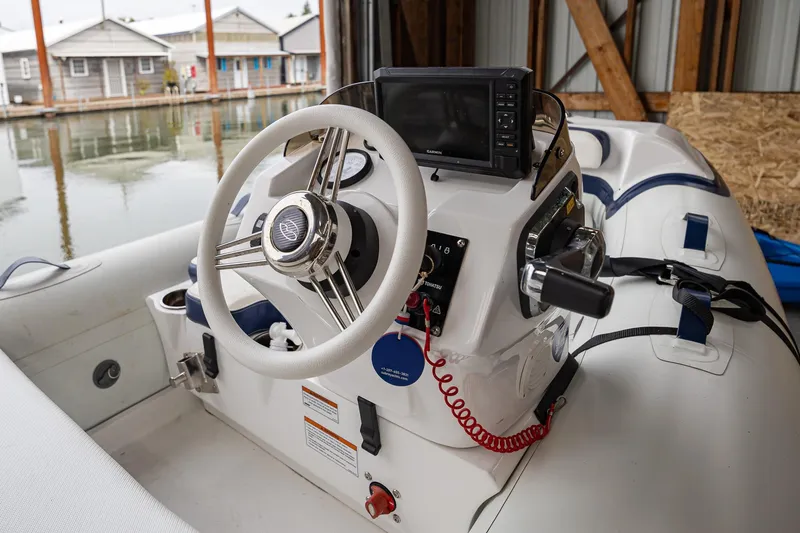 Slide: The Image of Interior view of 2023 Sabre 45 Salon Express boat cockpit with steering wheel and controls. - 67