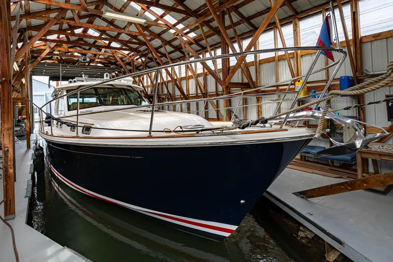 Slide: The Image of 2023 Sabre 45 Salon Express yacht docked in a wooden boathouse. - 7