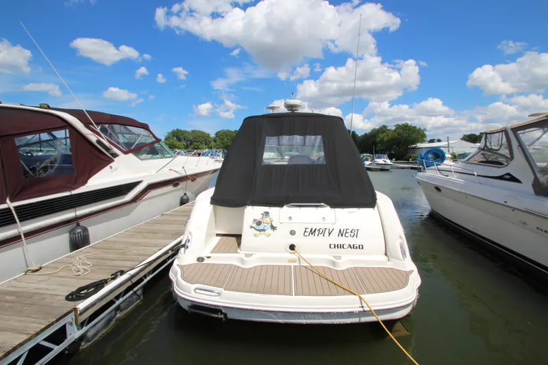 Slide: The Image of A 2005 Sea Ray 340 Sundancer docked, surrounded by other boats. - 1