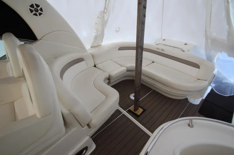 Slide: The Image of 2005 Sea Ray 340 Sundancer interior with white seating and wood flooring. - 25