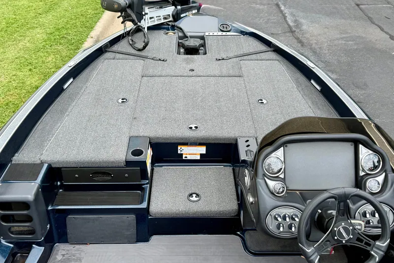 Slide: The Image of 2023 Triton 18 TrX boat interior with steering console and spacious deck layout. - 8