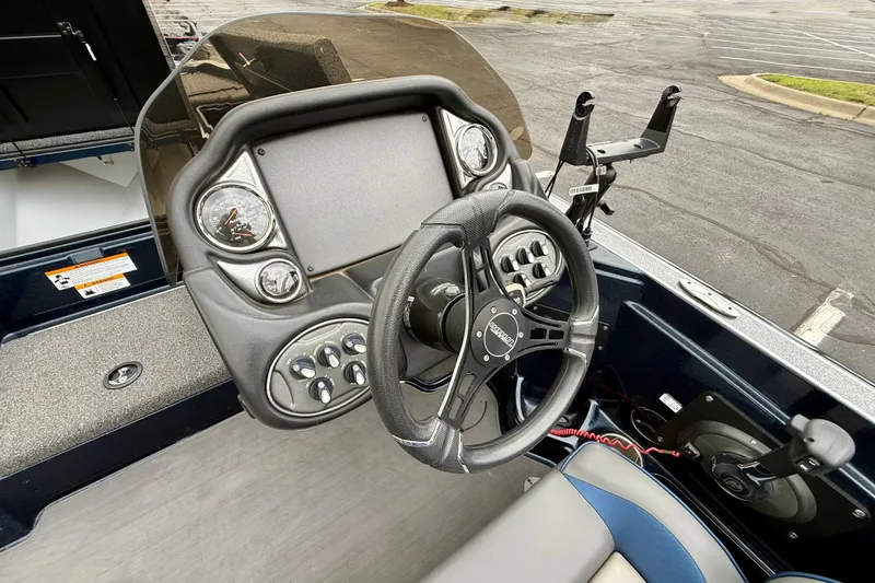 Slide: The Image of 2023 Triton 18 TrX boat dashboard with steering wheel and control panel. - 11