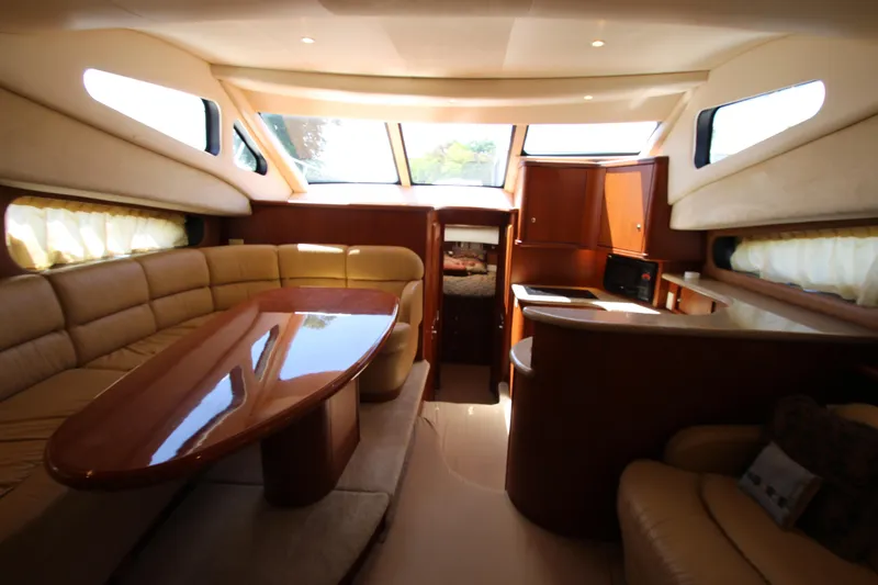 Slide: The Image of Luxurious interior of a 2006 Silverton 38 Sport Bridge yacht with elegant seating and dining area. - 10